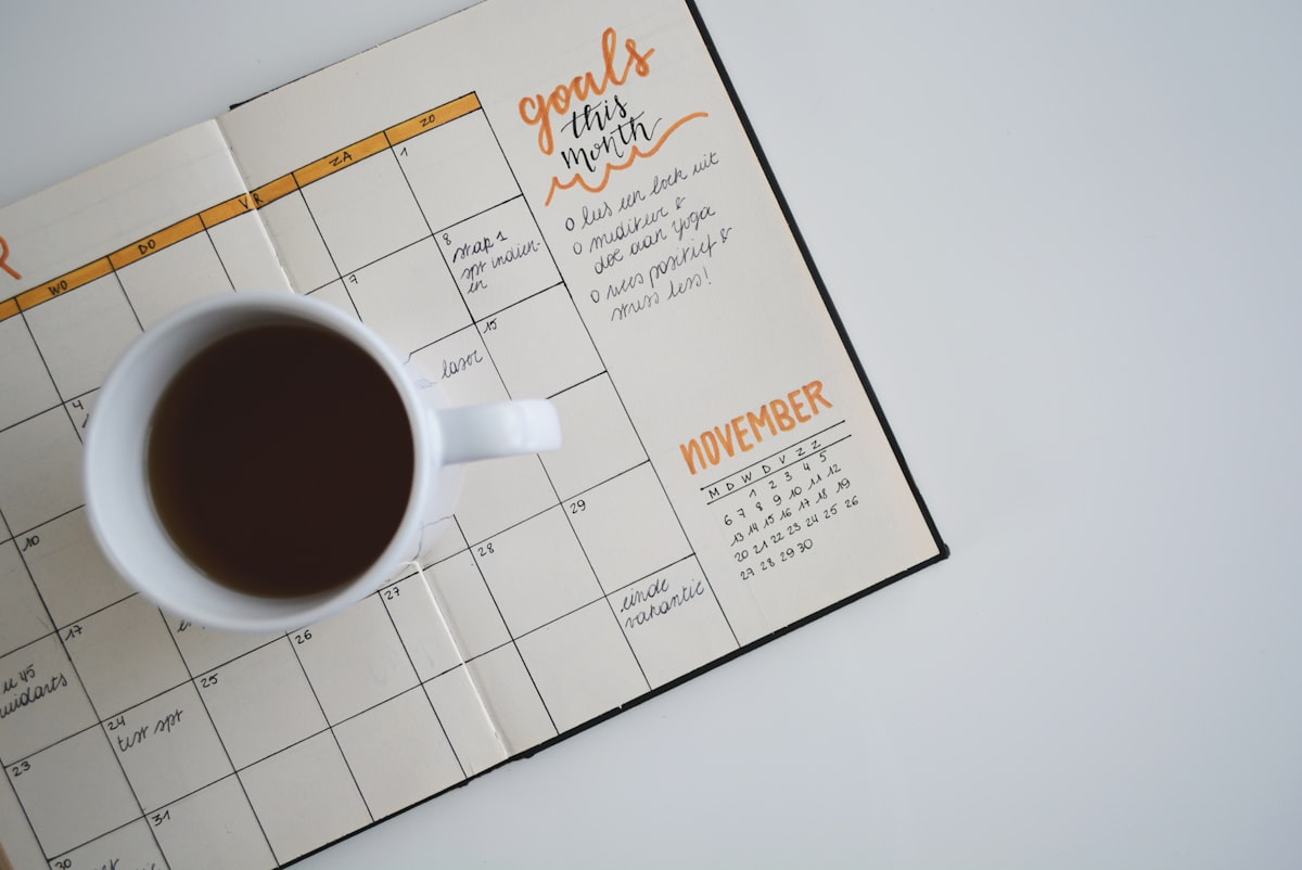 Open daily planner notebook with pen, ready for use on a clean desk