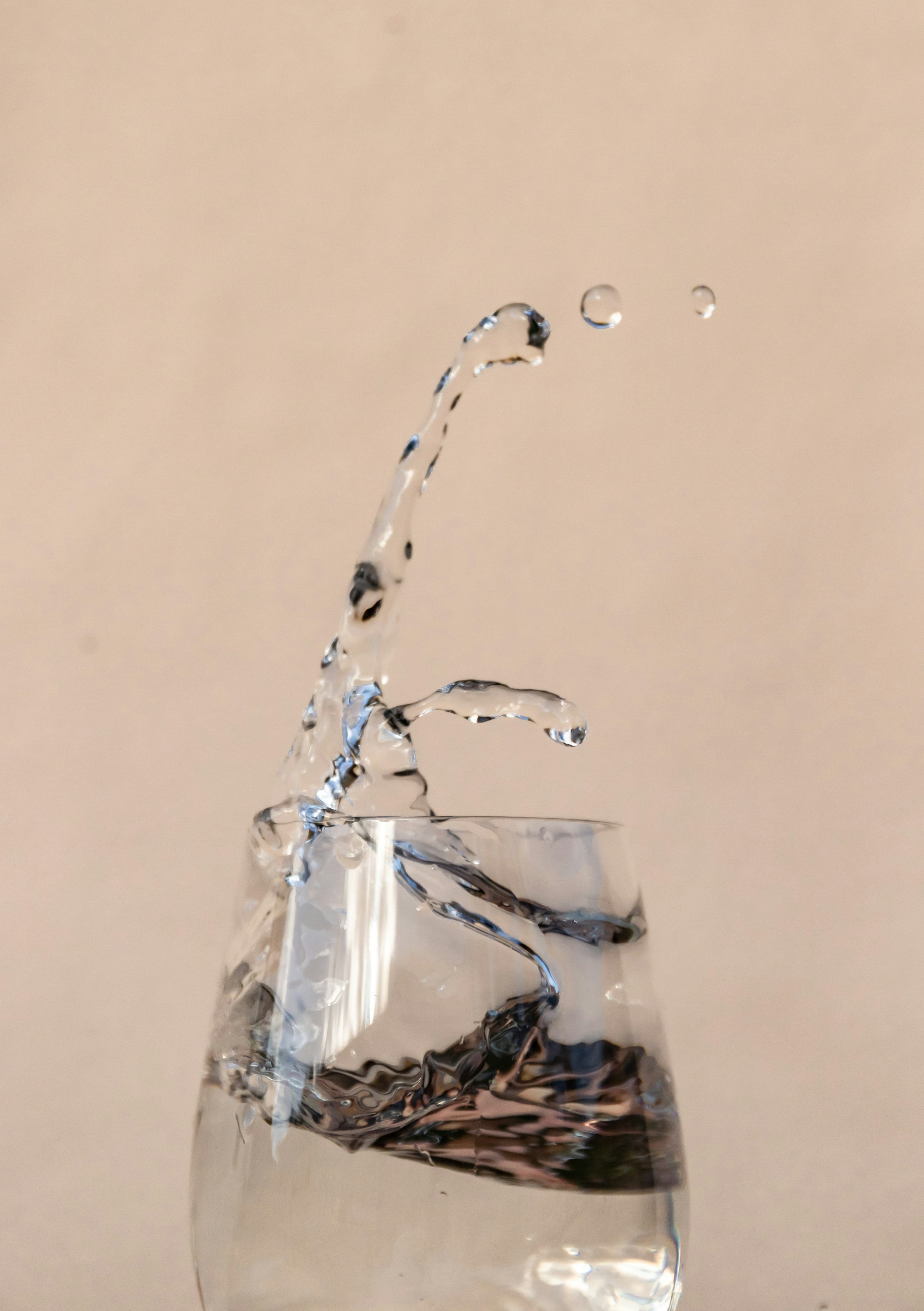 Water pouring into a clear glass