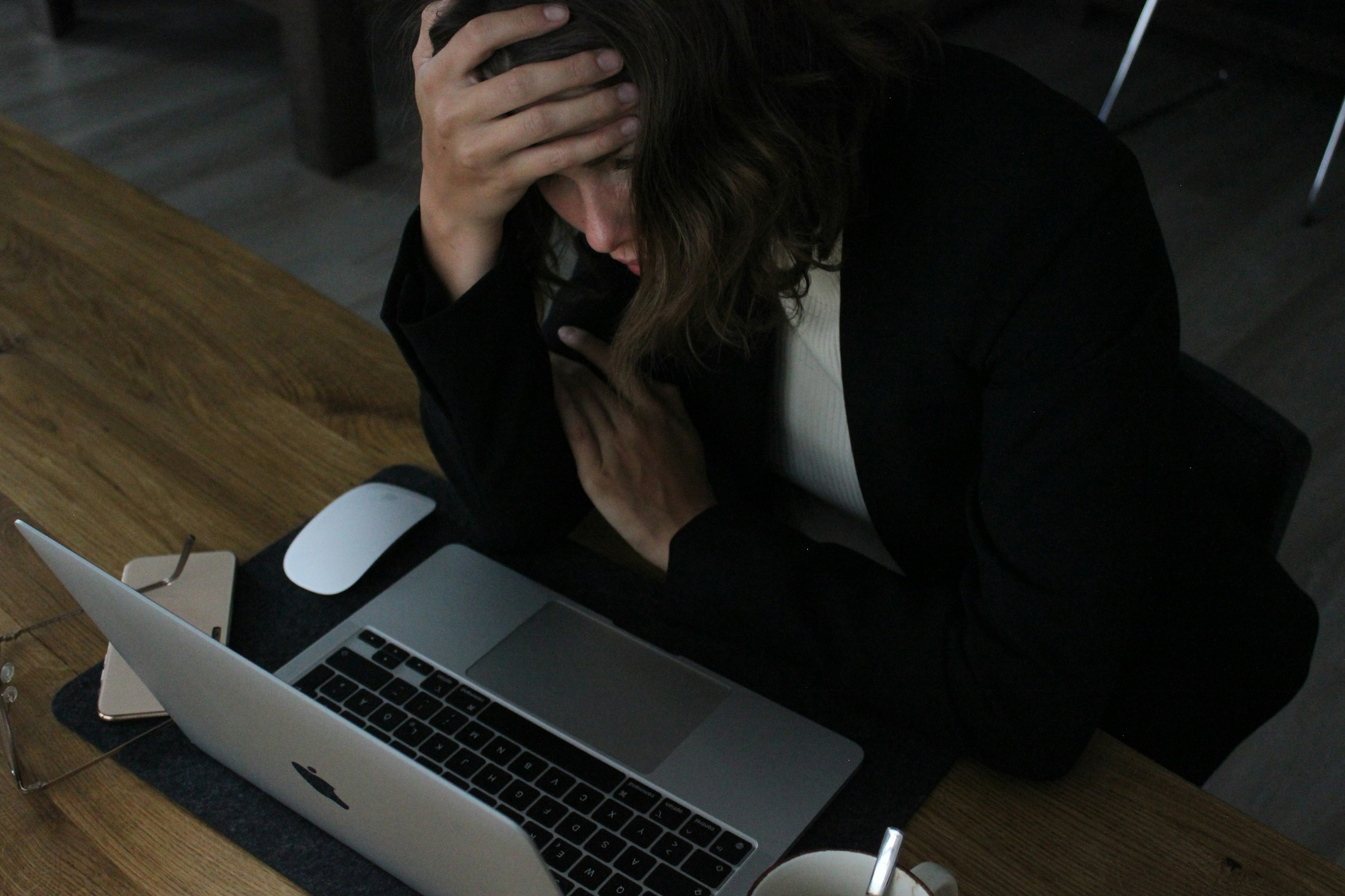 Fatigued professional with head down at desk