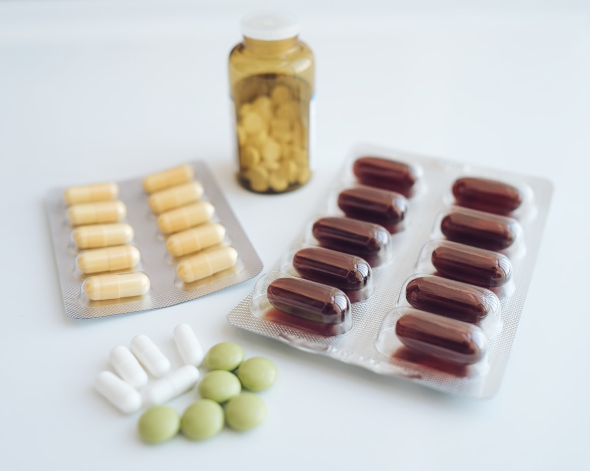 Vitamin and supplement bottles with capsules arranged on a table
